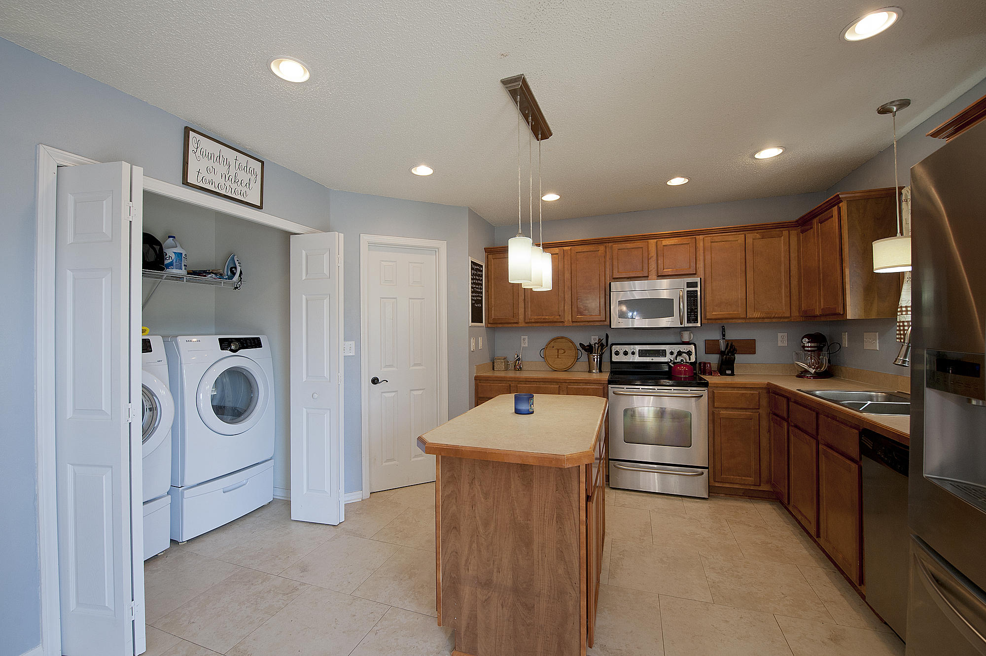 291 Limestone Circle Crestview, FL 32539 - Photo 8 of 19 a kitchen with stainless steel appliances kitchen island granite countertop a refrigerator and a stove top oven