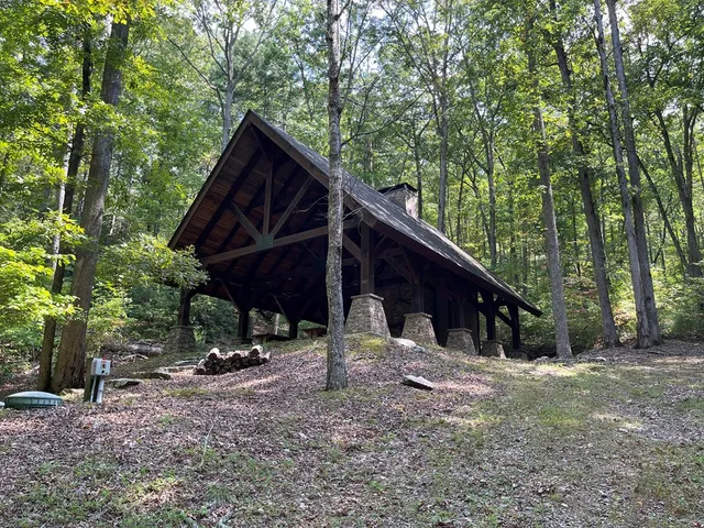 a view of house with backyard and sitting area