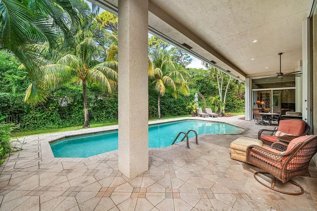 a swimming pool with outdoor seating and yard