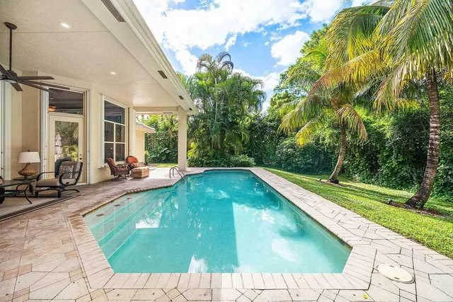 a swimming pool with outdoor seating and yard