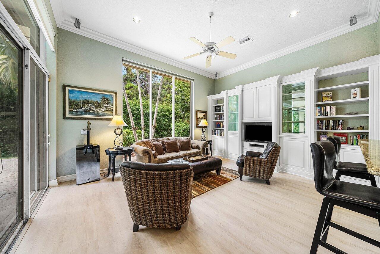 2560 Whispering Oaks Lane Delray Beach, FL 33445 - Photo 16 of 41 a living room with furniture and a floor to ceiling window