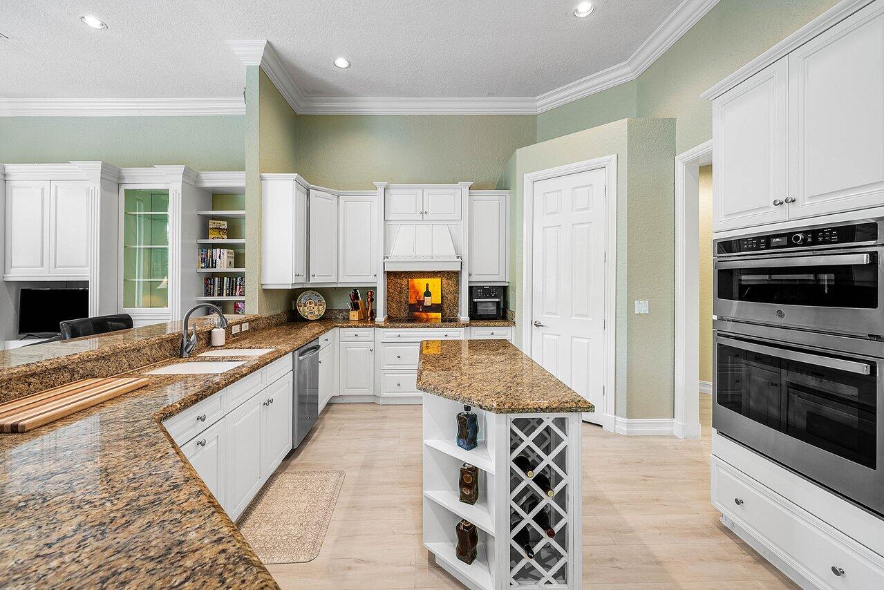 2560 Whispering Oaks Lane Delray Beach, FL 33445 - Photo 17 of 41 a large kitchen with stainless steel appliances granite countertop a stove and a sink
