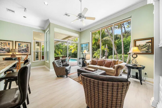 a living room with furniture and large windows