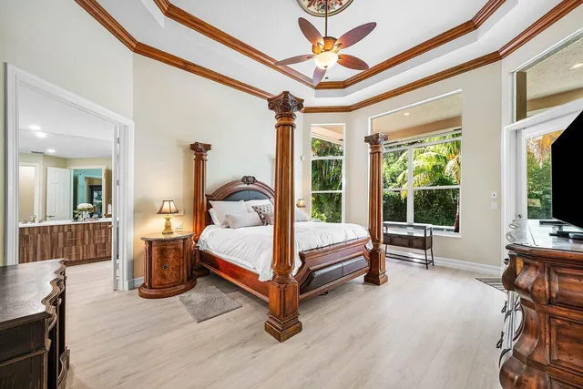 a bedroom with furniture and a large window