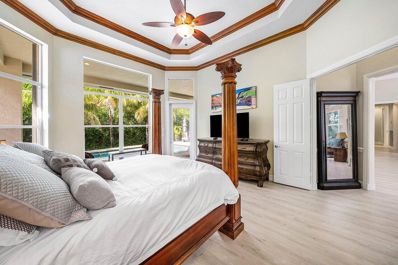 2560 Whispering Oaks Lane Delray Beach, FL 33445 - Photo 23 of 41 a bedroom with a bed and a large window with the outer view
