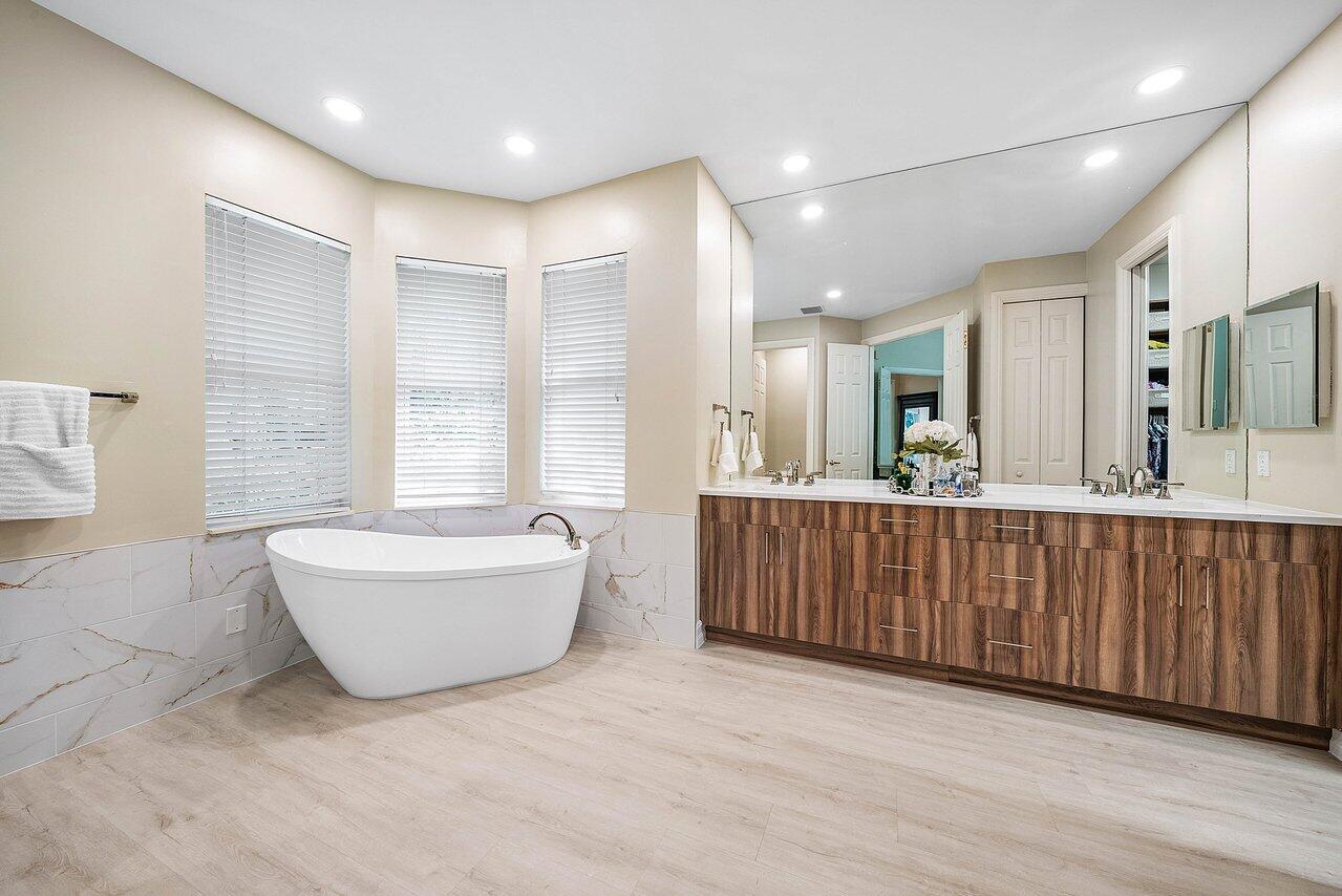 2560 Whispering Oaks Lane Delray Beach, FL 33445 - Photo 26 of 41 a bathroom with a granite countertop sink mirror and bathtub