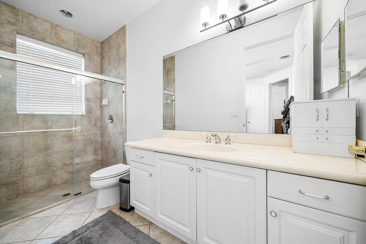 2560 Whispering Oaks Lane Delray Beach, FL 33445 - Photo 32 of 41 a bathroom with a sink toilet and shower