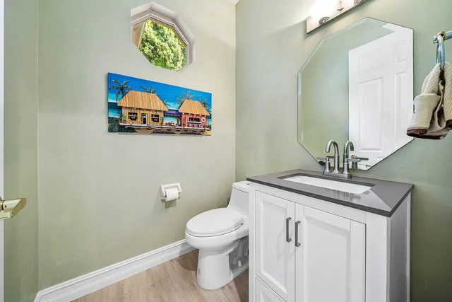 a bathroom with a toilet a sink and mirror