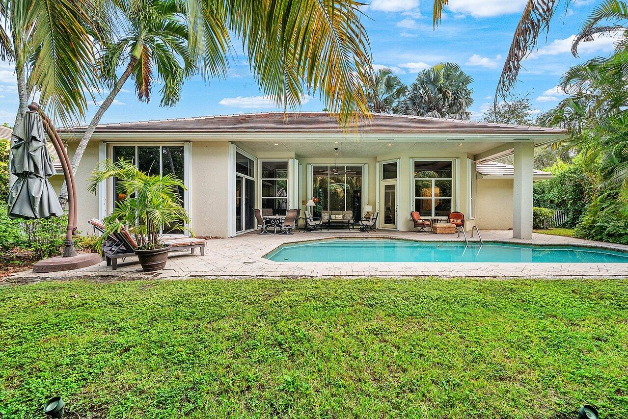 2560 Whispering Oaks Lane Delray Beach, FL 33445 - Photo 35 of 41 front view of a house with a patio
