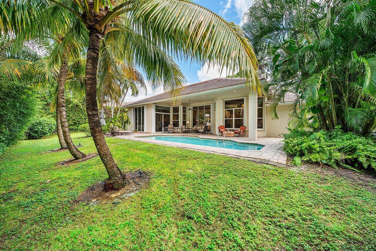 2560 Whispering Oaks Lane Delray Beach, FL 33445 - Photo 36 of 41 a view of a house with a backyard and a patio