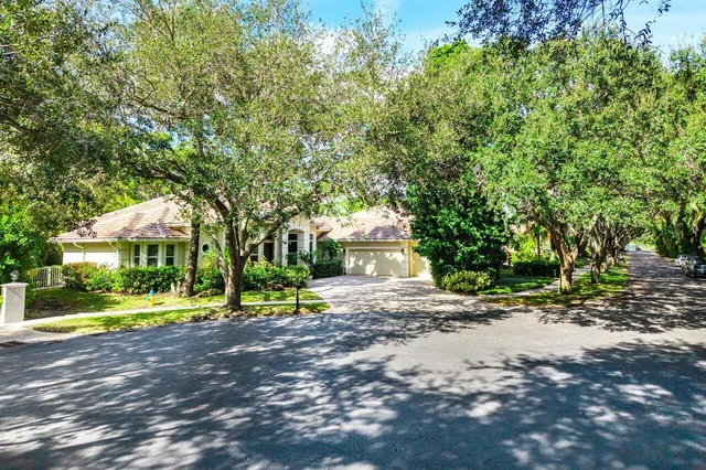a view of street with yellow house in the background