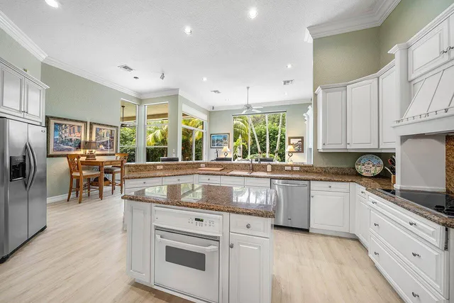a kitchen with stainless steel appliances granite countertop a stove and a sink