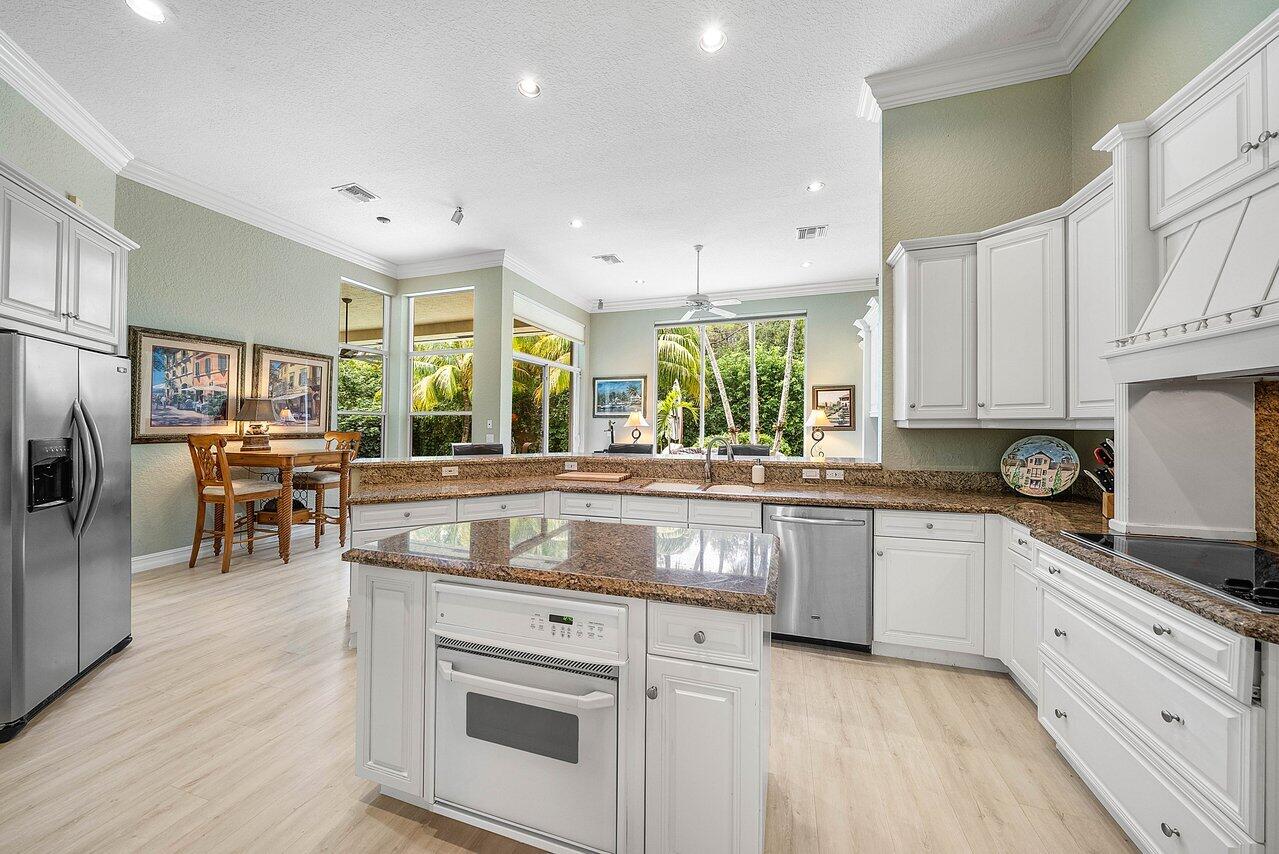 2560 Whispering Oaks Lane Delray Beach, FL 33445 - Photo 7 of 41 a kitchen with stainless steel appliances granite countertop a stove and a sink