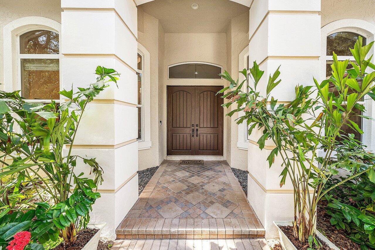 2560 Whispering Oaks Lane Delray Beach, FL 33445 - Photo 9 of 41 a front view of a house with a yard