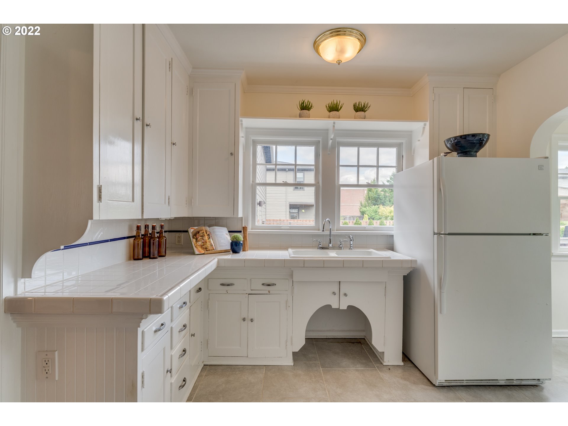 3310 Northeast 70th Avenue Portland, OR 97213 - Photo 10 of 21 a kitchen with a sink a window and stainless steel appliances