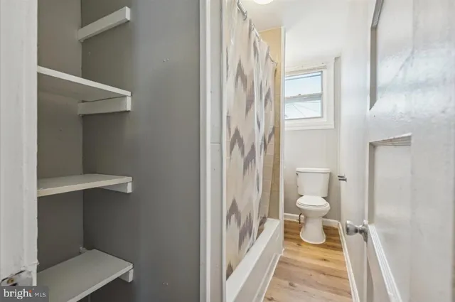 a bathroom with a toilet and a shower