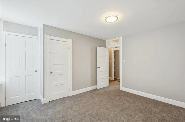 an empty room with closet area