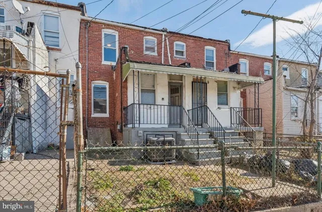 a view of a brick house with large windows