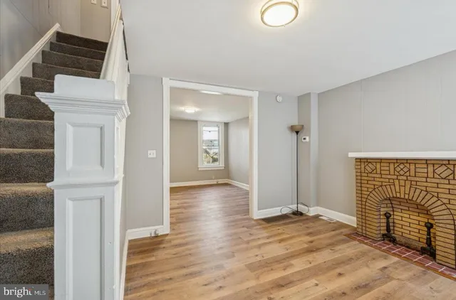 a view of empty room with wooden floor