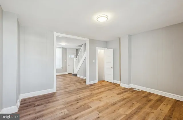 a view of an empty room and wooden floor