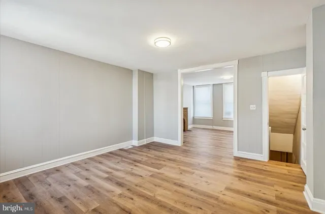 a view of a room with wooden floor