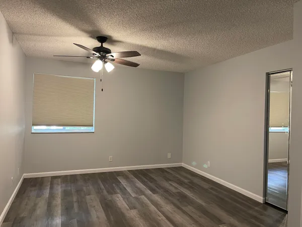 a view of an empty room with a fan