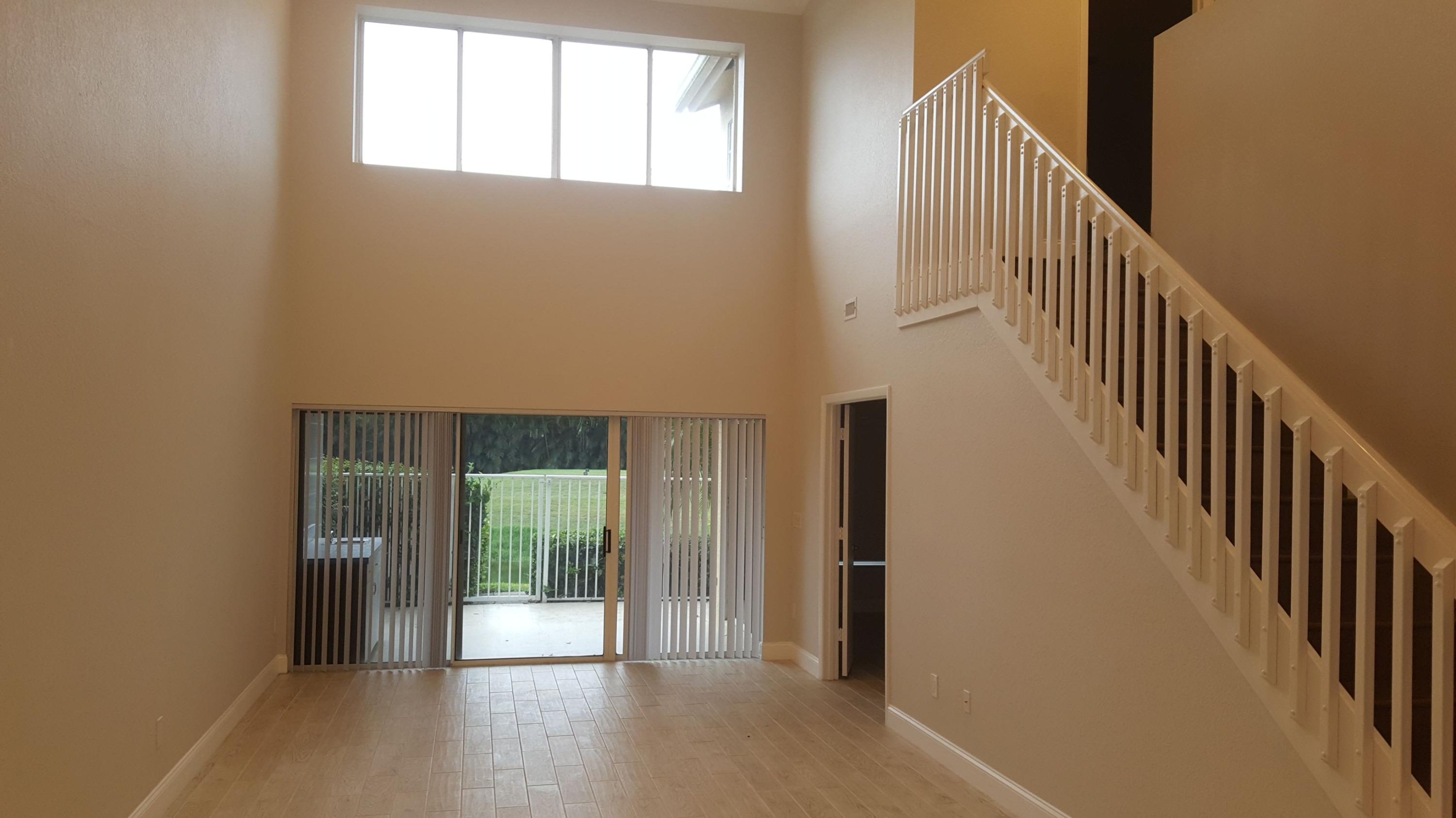 17046 Boca Club Boulevard, Unit 6 Boca Raton, FL 33487 - Photo 2 of 16 a view of a hallway with wooden floor and stairs