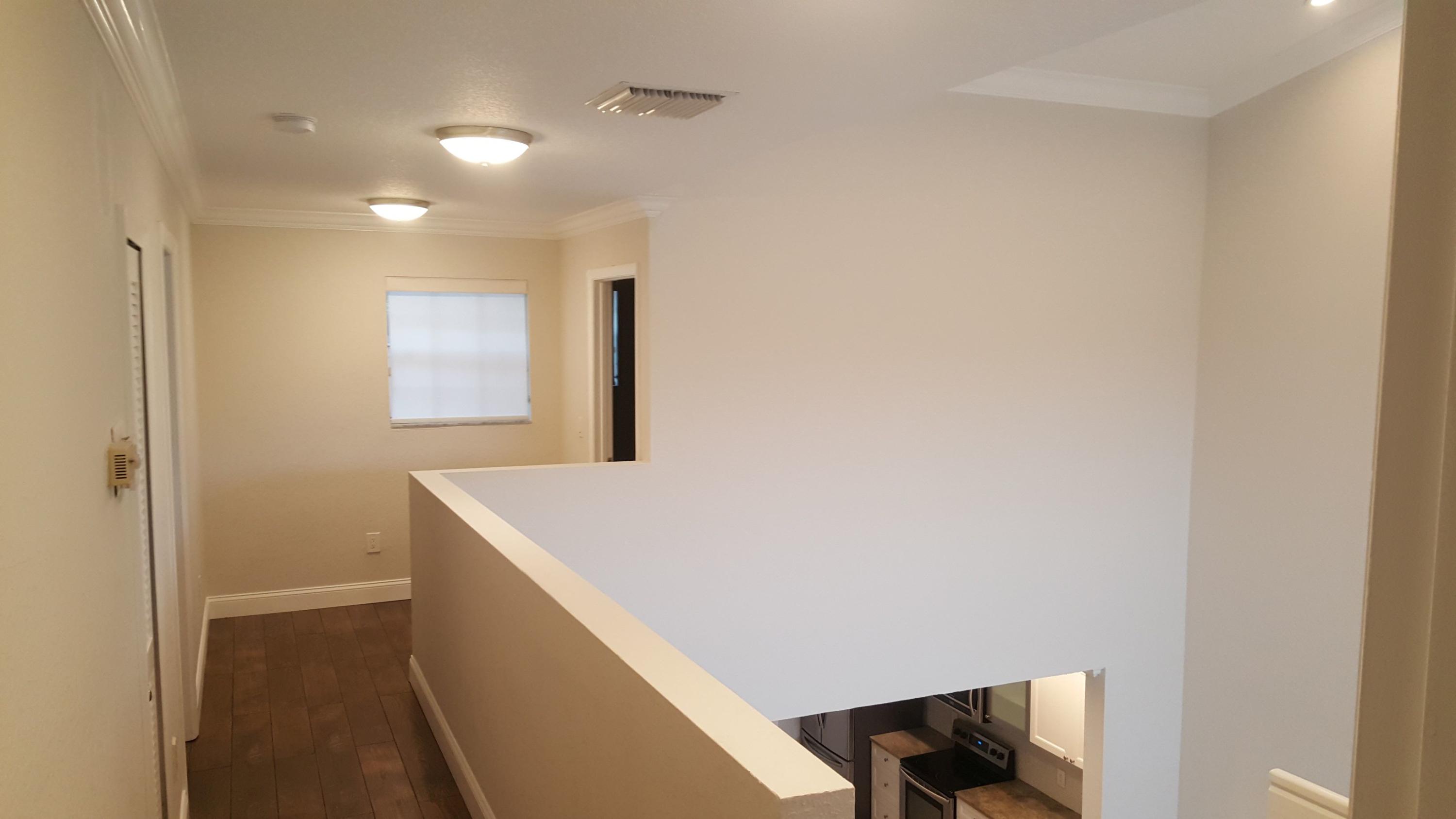 17046 Boca Club Boulevard, Unit 6 Boca Raton, FL 33487 - Photo 7 of 16 a hallway with washer and dryer