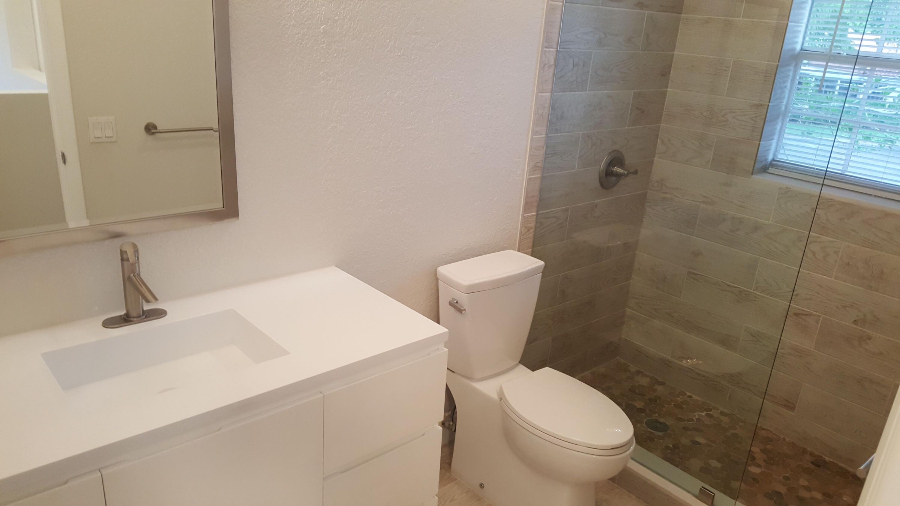 17046 Boca Club Boulevard, Unit 6 Boca Raton, FL 33487 - Photo 9 of 16 a white toilet sitting next to a bathroom sink