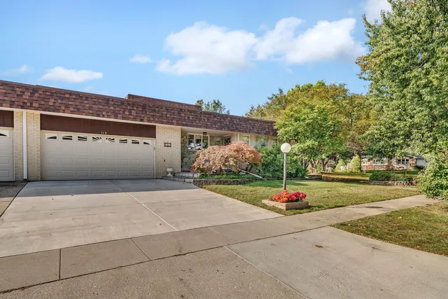 a street view with a building and trees in the background