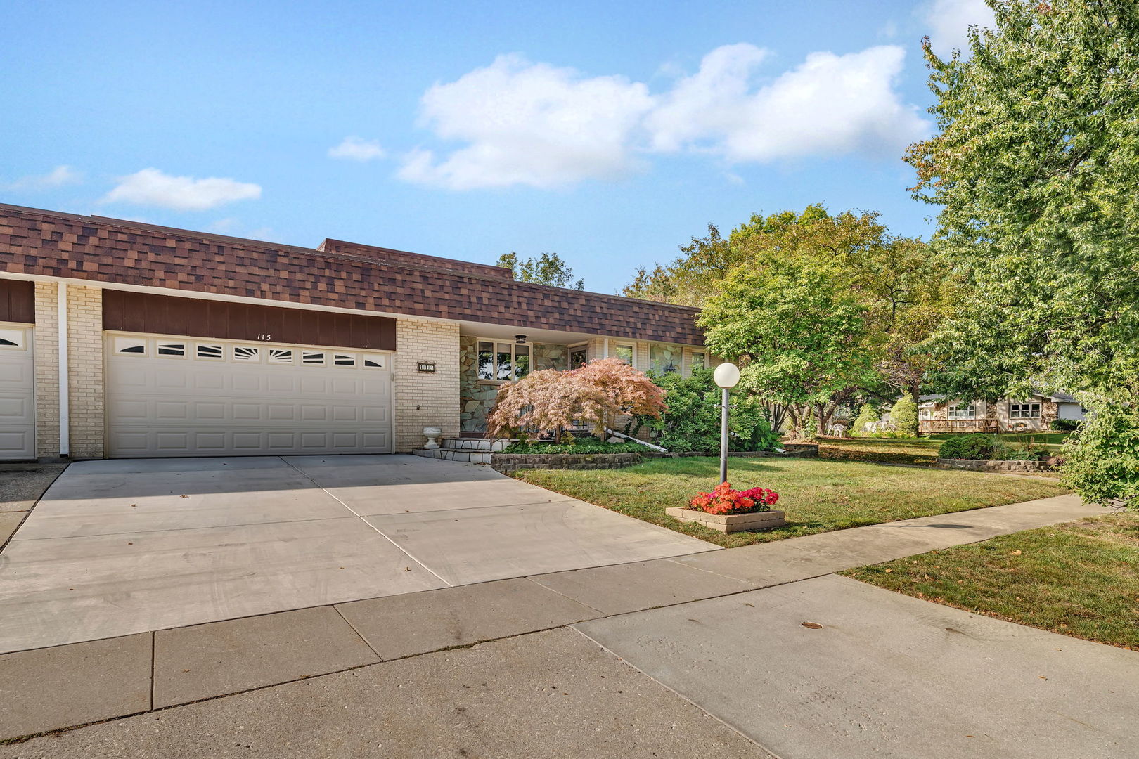a street view with a building and trees in the background