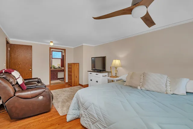 a bedroom with furniture and a flat screen tv
