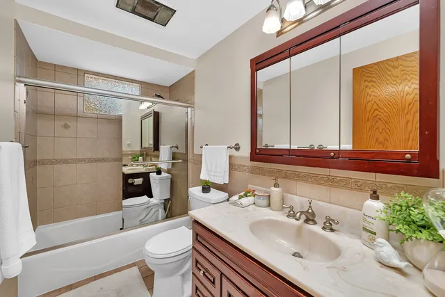 a bathroom with a sink toilet tub and shower