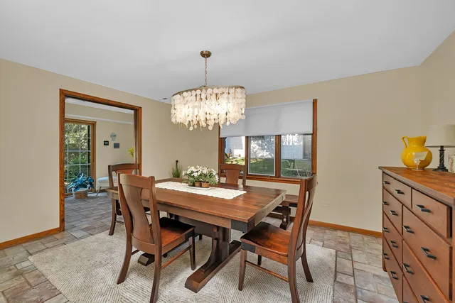 a view of a dining room with furniture and chandelier