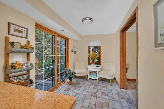 a living room with furniture a flat screen tv and a window