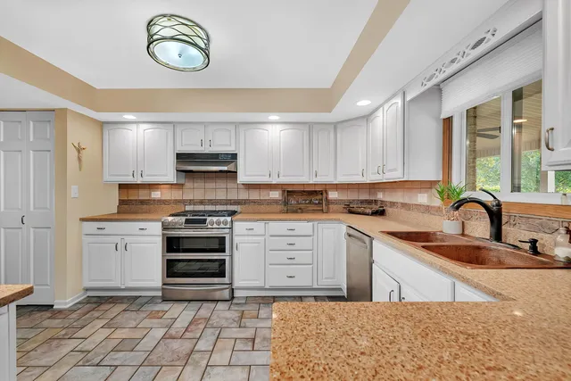 a kitchen with a stove a sink and a microwave