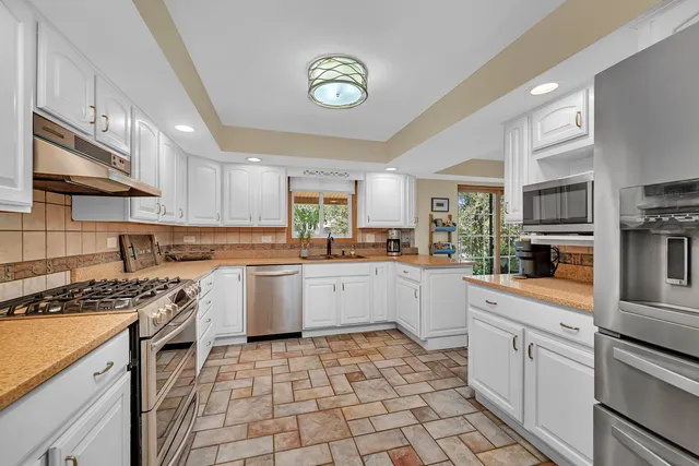 a kitchen with a sink stove and cabinets
