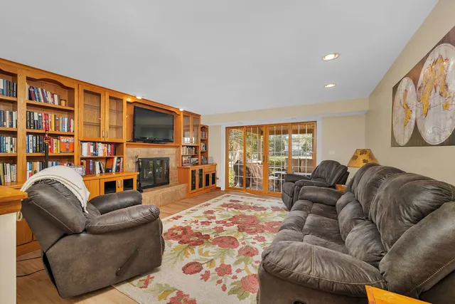 a living room with fireplace furniture and a flat screen tv