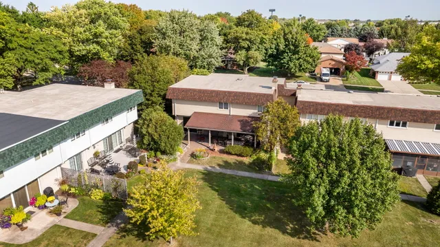 an aerial view of multiple houses with yard