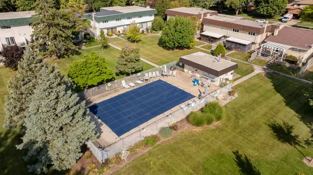 an aerial view of a house with a yard