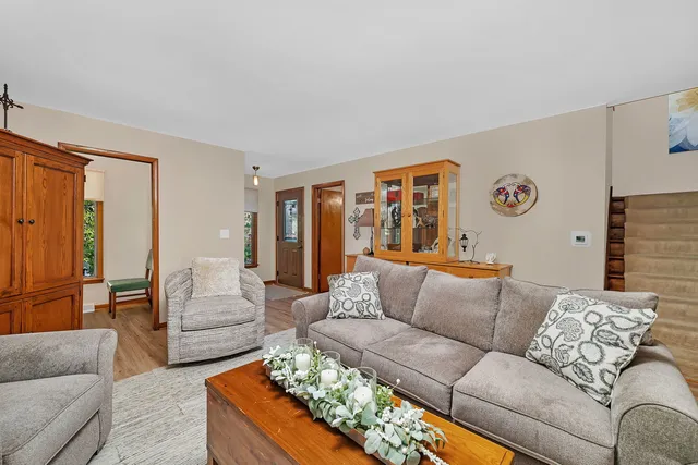 a living room with furniture and painting on the wall