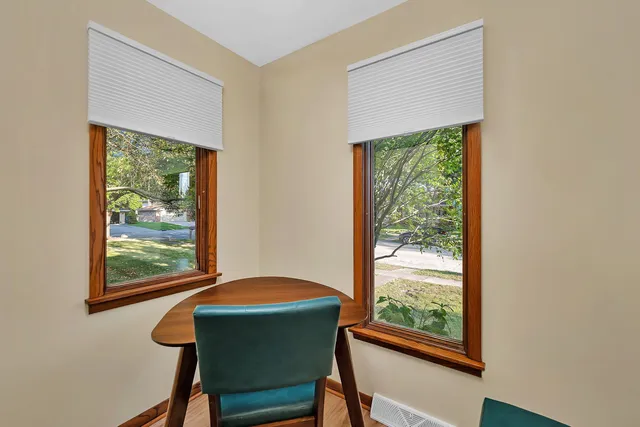 a workspace room with furniture and a window