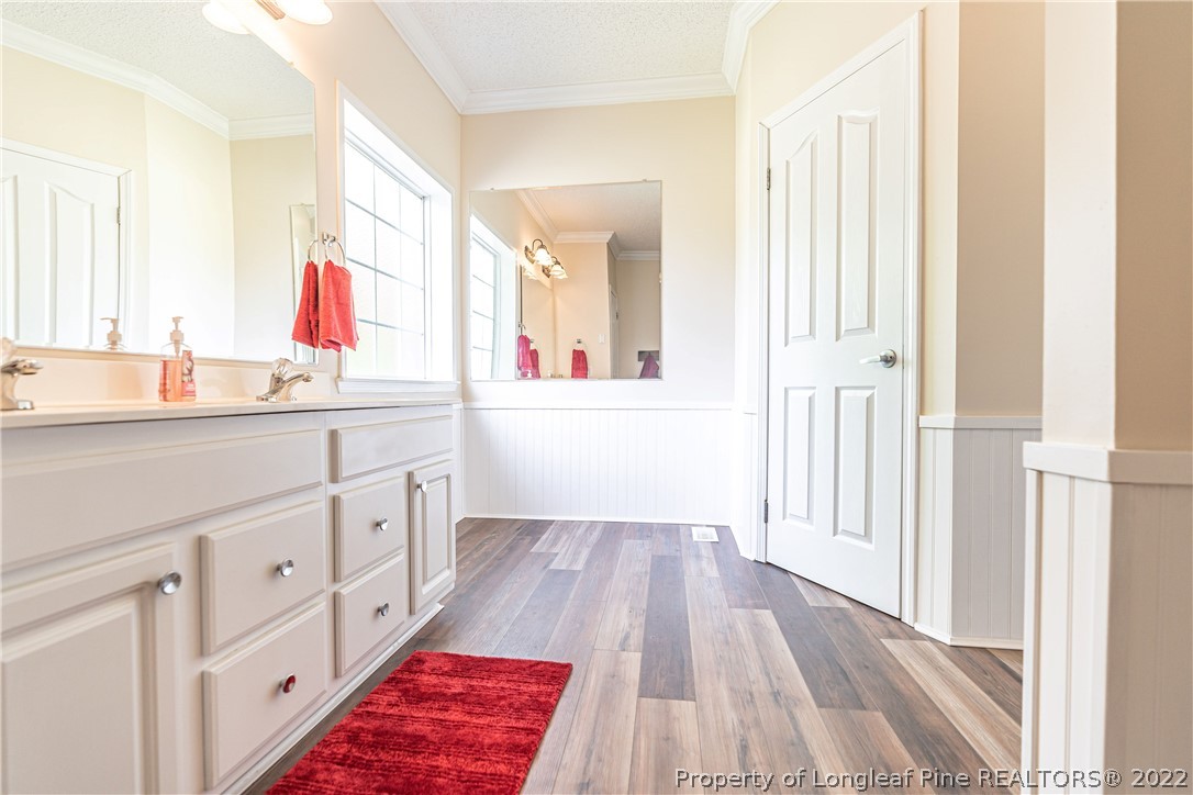 270 Morrison Bridge Road Vass, NC 28394 - Photo 26 of 50 a bathroom with a sink a mirror a vanity and a window
