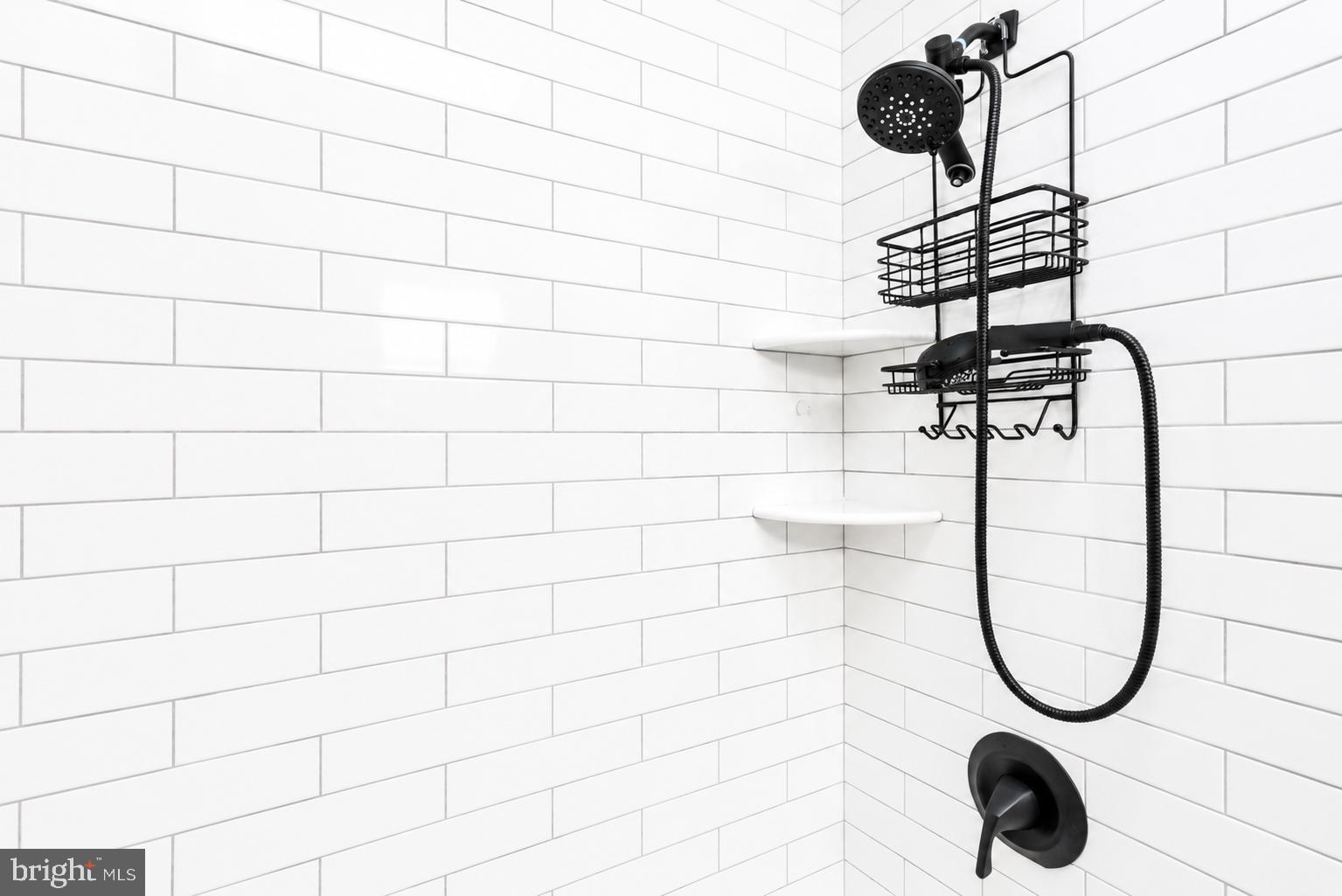 104 Westbridge Road, Unit 120 Glenolden, PA 19036 - Photo 28 of 37 Sleek black shower fixtures on white tiles.