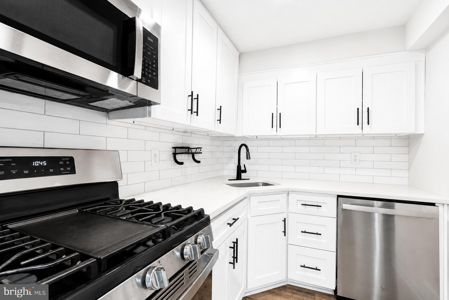 104 Westbridge Road, Unit 120 Glenolden, PA 19036 - Photo 6 of 37 Sleek modern kitchen with white accents.