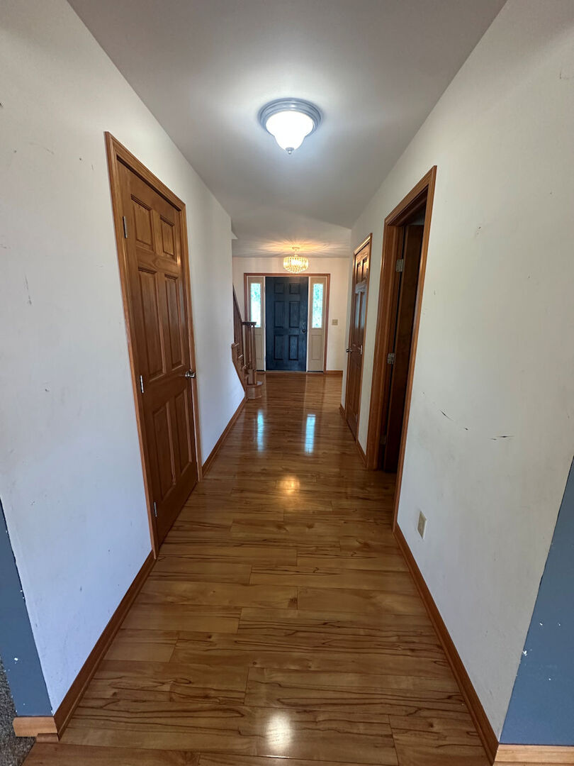519 South Regulators Street Rochelle, IL 61068 - Photo 8 of 19 a view of a hallway with wooden floor and staircase