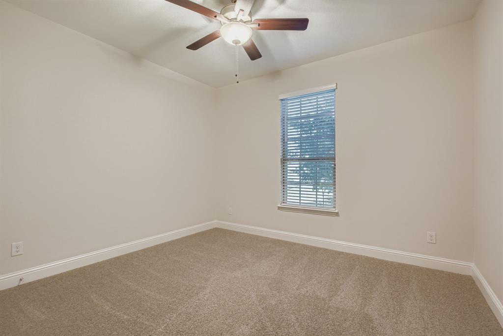 312 Magnolia Drive Oak Point, TX 75068 - Photo 19 of 28 Carpeted empty room featuring baseboards and ceiling fan