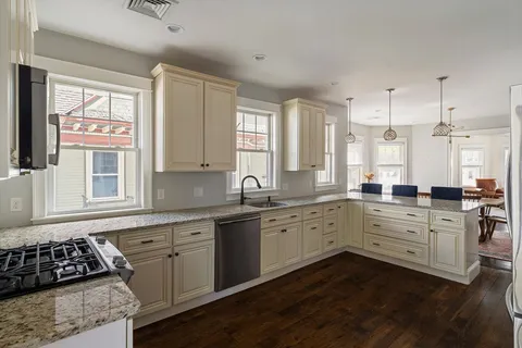a kitchen that has a sink and a stove in it