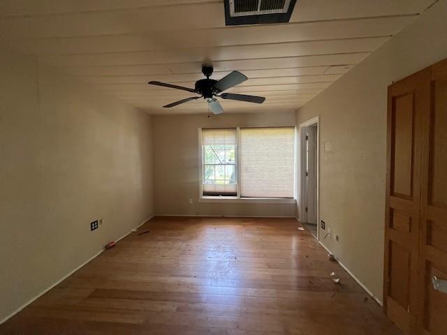 2106 Cleveland Street Paris, TX 75460 - Photo 6 of 7 an empty room with wooden floor and windows