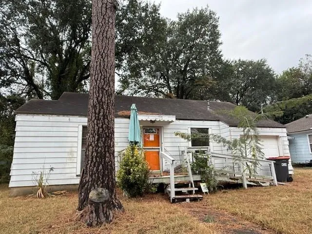 a view of a house with a yard and sitting area